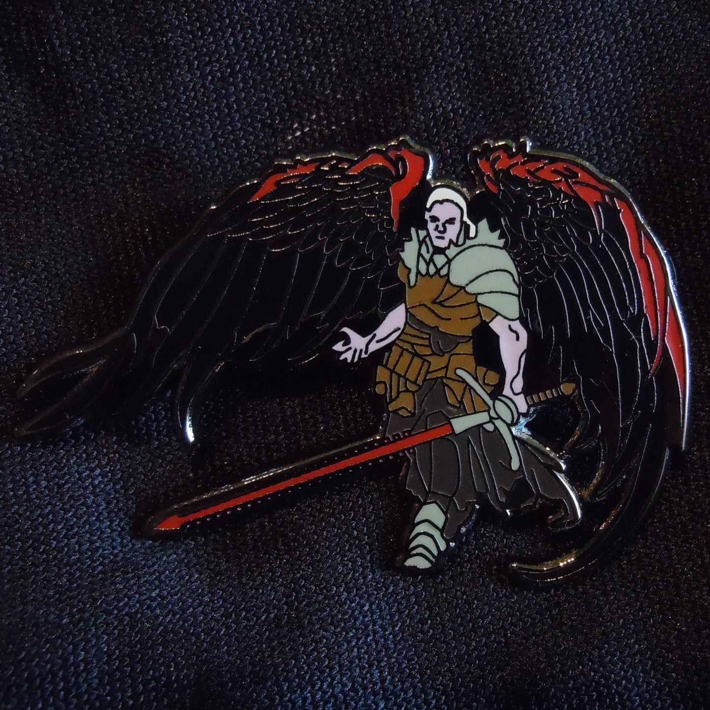 A picture of the hard enamel angel of blood pin from Injuries and Vile Deeds for dnd 5e